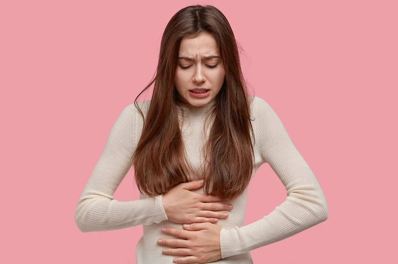 Woman holding stomach in pain