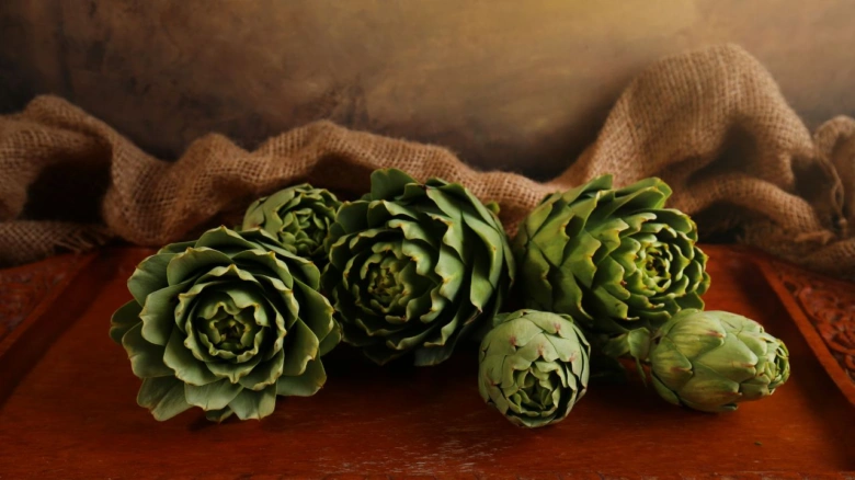Artichokes on wooden surface