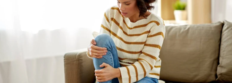 Woman holding knee in pain