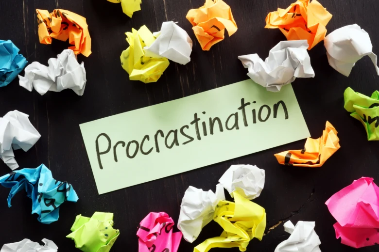 Crumpled papers with word procrastination