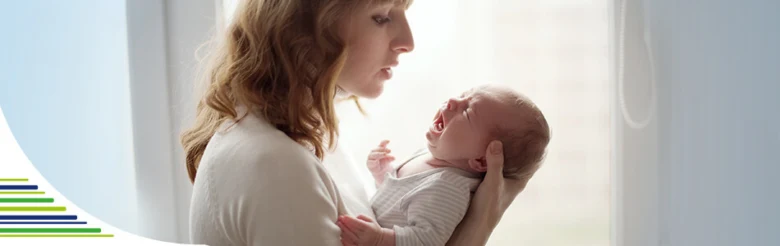 Mother holding crying baby