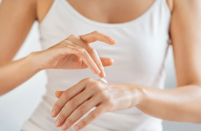 Woman applying hand cream