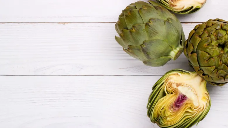 Artichokes on white wood