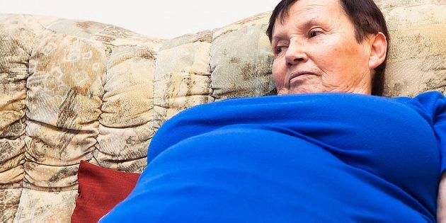 Overweight woman on couch