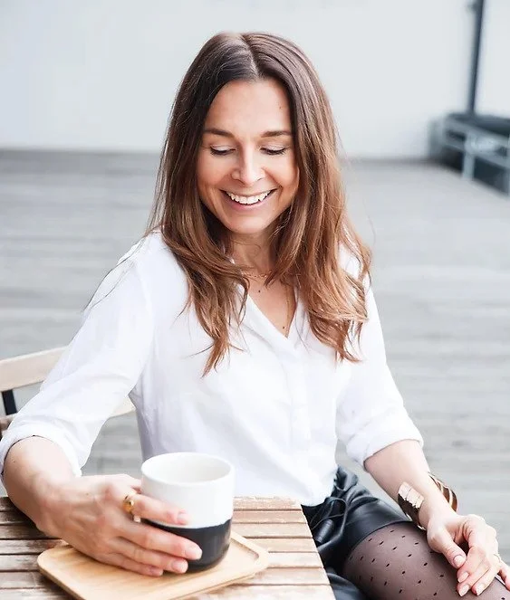 Žena pije kávu venku, ilustrační foto pro menopauzu.