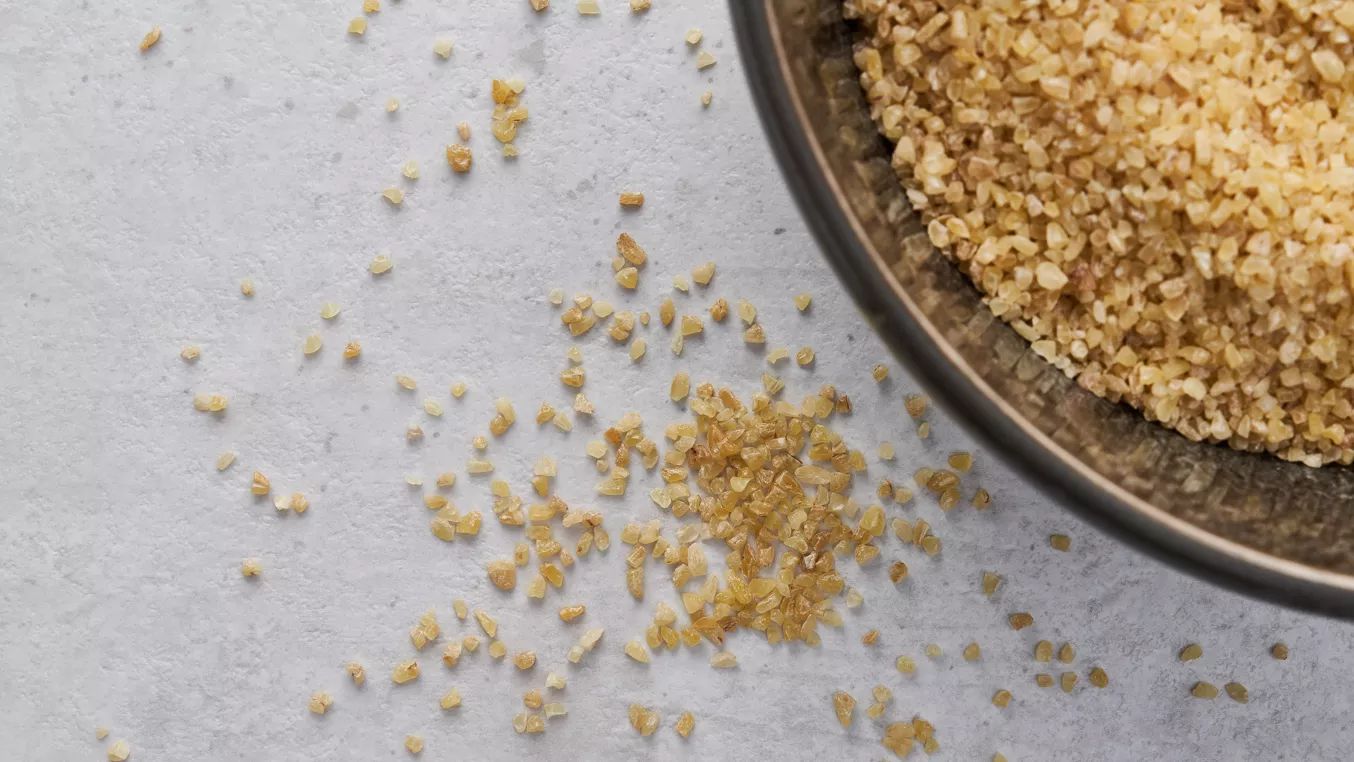 Amaranth grains in bowl and scattered