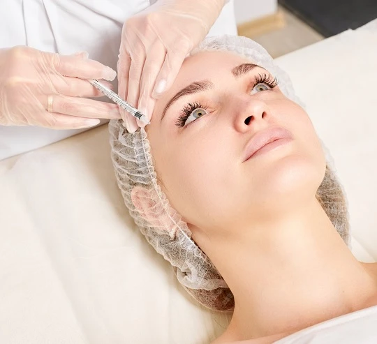 Žena dostává estetickou péči o obličej pro zpevnění pleti.