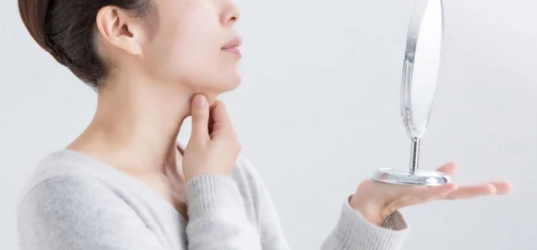 Woman checking neck skin