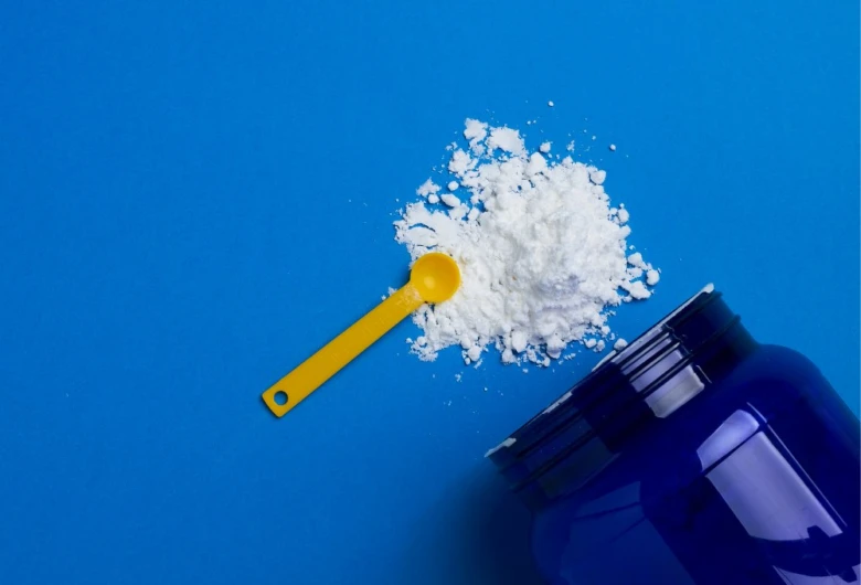 Creatine powder and scoop