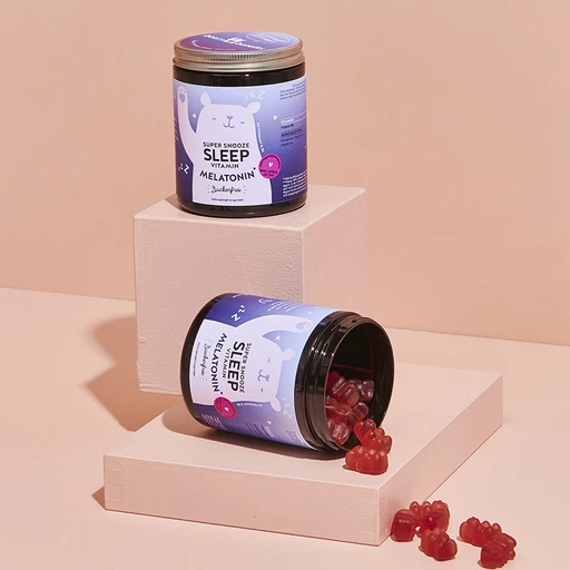 Kontejner s meduňkovými vitamíny na bloku pro článek o spánku.